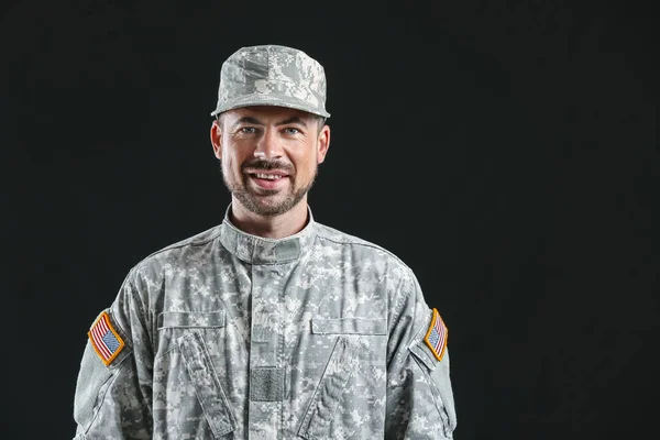 Soldier in camouflage on dark background — Stock Photo, Image