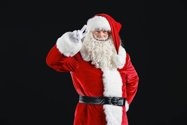 Portrait of cool Santa Claus on dark background