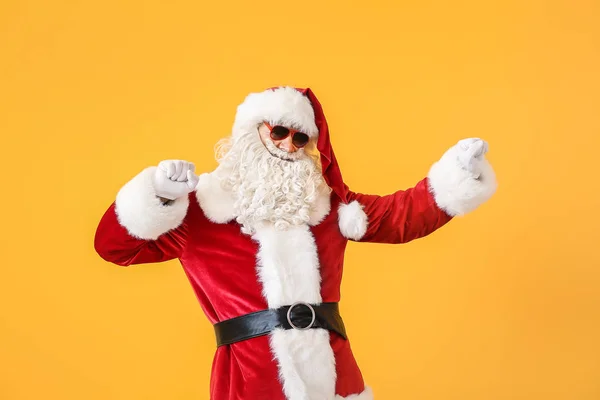 Portrait of cool dancing Santa Claus on color background — Stock Photo, Image