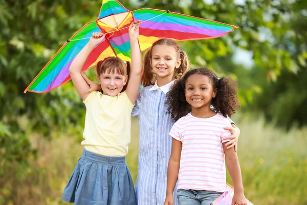 Little girls flying kite outdoors — Stock Photo, Image