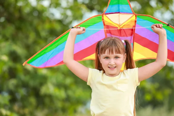 Little girl flying kite outdoors — Stock Photo, Image