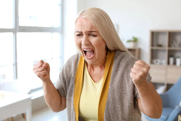 Angry mature woman at home — Stock Photo, Image