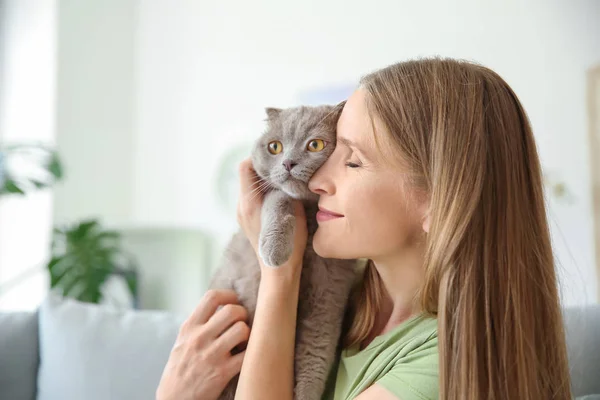 Beautiful woman with cute cat at home — Stock Photo, Image