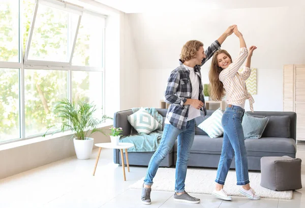 Happy young couple dancing at home — Stock Photo, Image