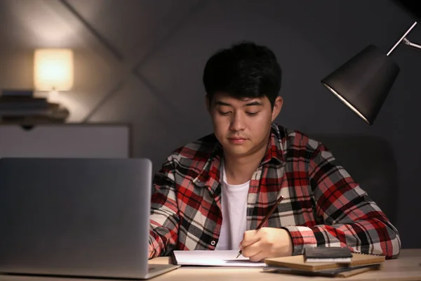 Asian student preparing for exam late in evening — Stock Photo, Image