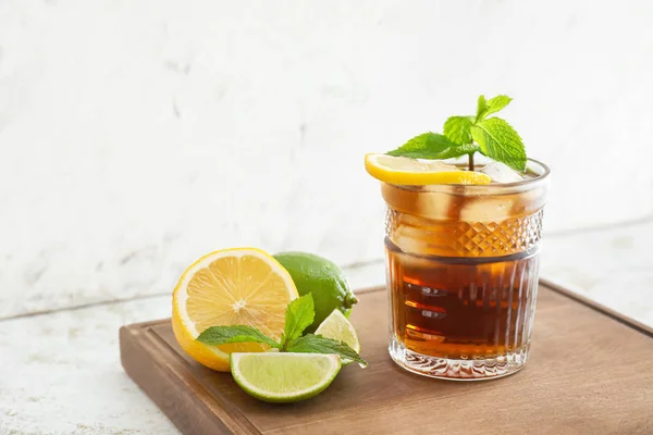 Glass of cold cola, lemon and lime on table — Stock Photo, Image