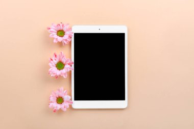 Renkli arka planda çiçeklerle modern tablet bilgisayar