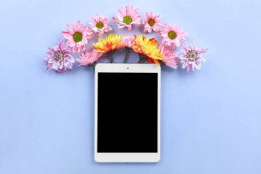Renkli arka planda çiçeklerle modern tablet bilgisayar