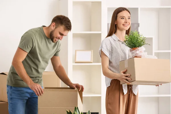 Jovem casal feliz com pertences em sua nova casa — Fotografia de Stock