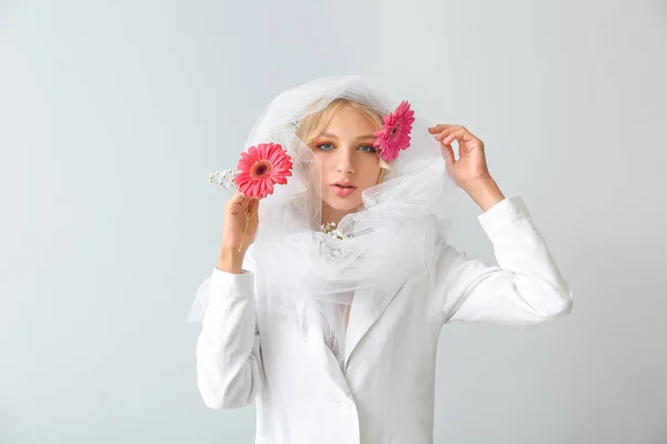 Beautiful young woman with gerbera flowers on white background — Stock Photo, Image