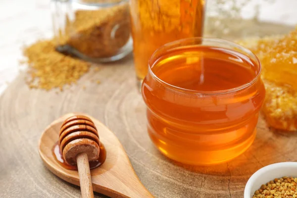 Jar of sweet honey and dipper on table — Stock Photo, Image