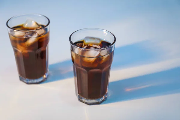 Glasses of cold cola on light background — Stock Photo, Image