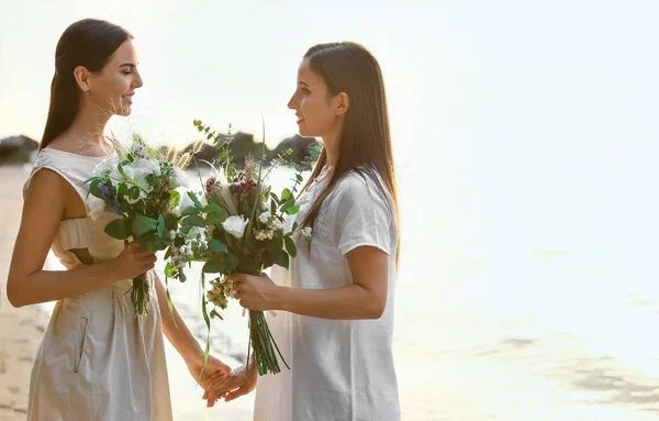 Beautiful lesbian couple on their wedding day near river — Stock Photo, Image