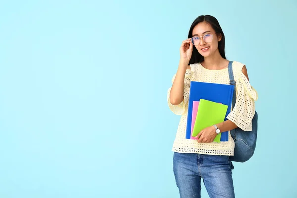 Portrait of Asian student on color background — Stock Photo, Image