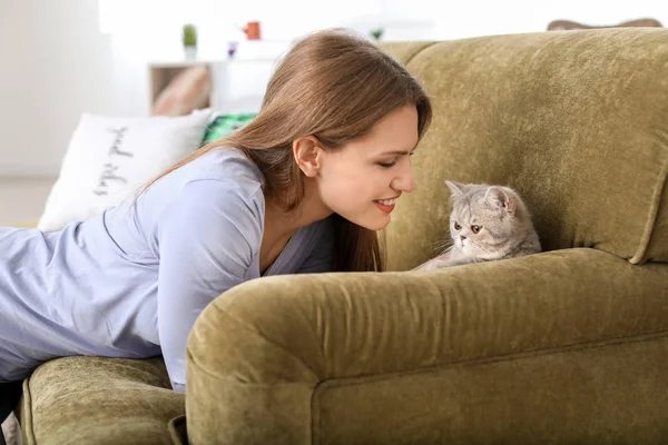 Beautiful young woman with cute cat at home — Stock Photo, Image