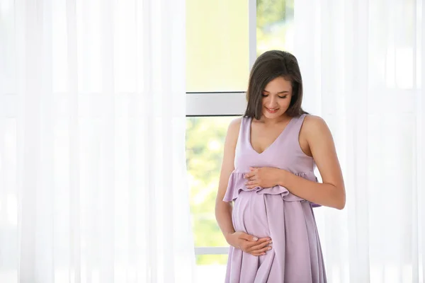 Young pregnant woman near window — Stock Photo, Image