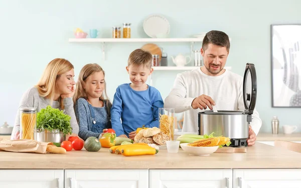 Happy family using modern multi cooker in kitchen — Stock Photo, Image