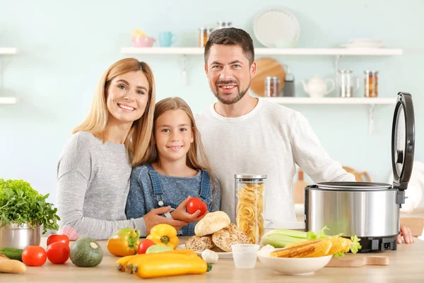 Happy family with modern multi cooker in kitchen — Stock Photo, Image