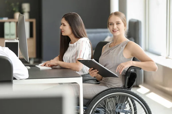 Mujer joven discapacitada con colegas que trabajan en la oficina — Foto de Stock