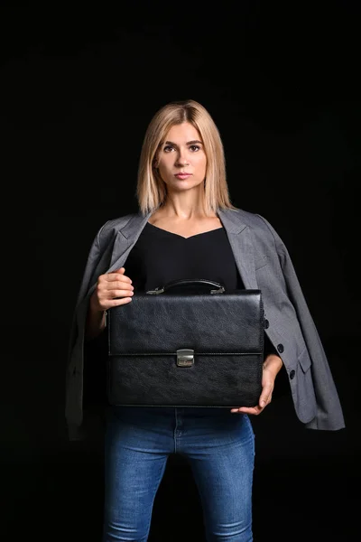 Beautiful stylish businesswoman with briefcase on dark background — Stock Photo, Image