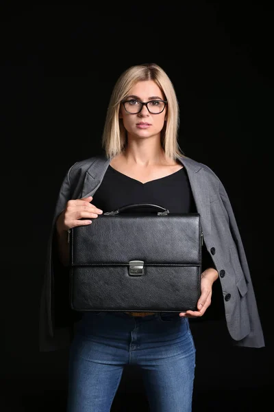 Beautiful stylish businesswoman with briefcase on dark background — Stock Photo, Image