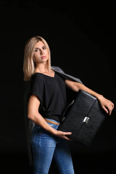Beautiful stylish businesswoman with briefcase on dark background — Stock Photo, Image