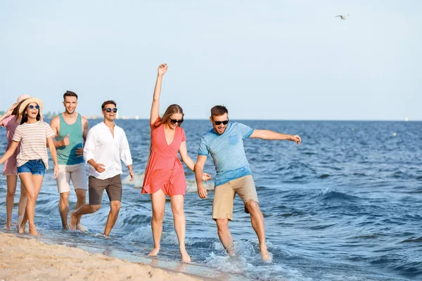 Happy friends on sea beach at resort — Stock Photo, Image