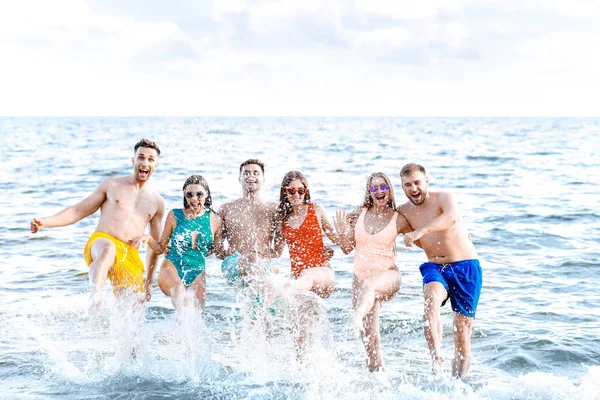 Happy friends on sea beach at resort — Stock Photo, Image