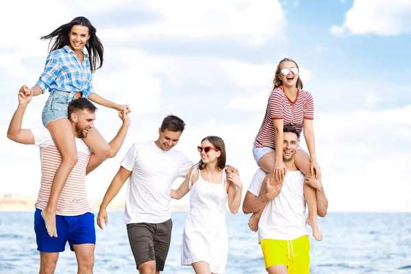 Felices amigos en la playa del mar en el resort — Foto de Stock