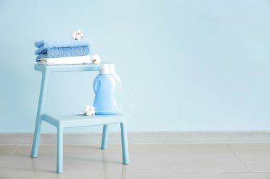 Renkli duvara yakın temiz havlu lar ve yıkama maddeleri ile stand