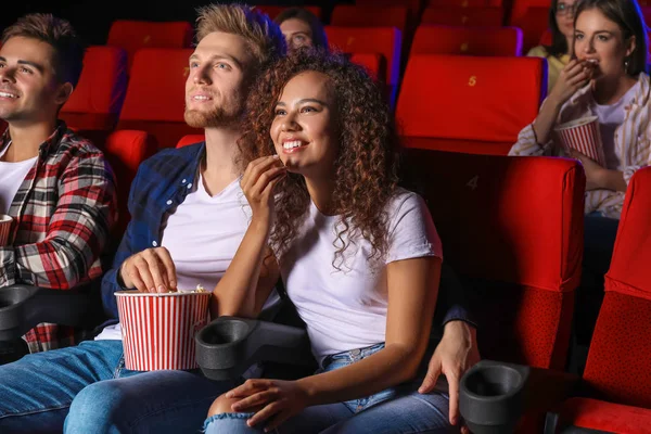 Couple with popcorn watching movie in cinema — Stock Photo, Image