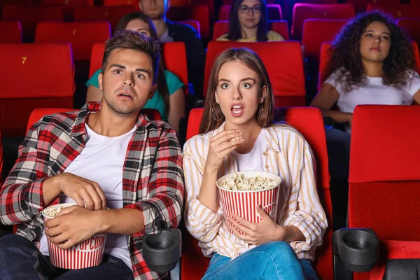 Couple with popcorn watching movie in cinema — Stock Photo, Image