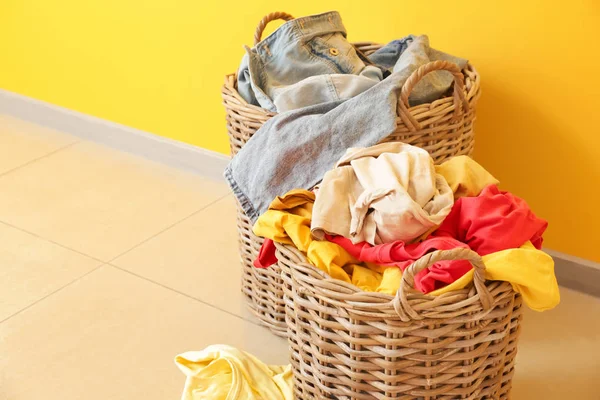 Baskets with dirty laundry on floor