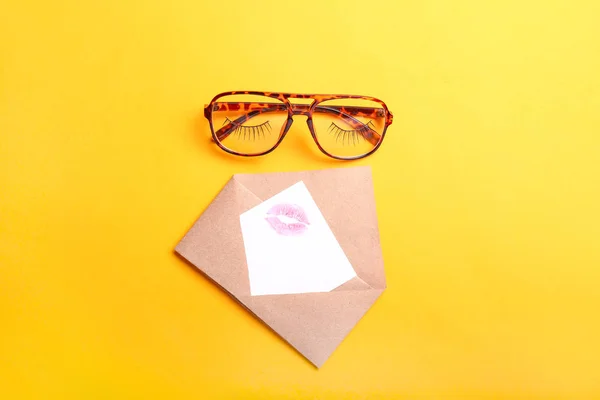 Stylish eyeglasses with envelope and letter on color background — Stock Photo, Image