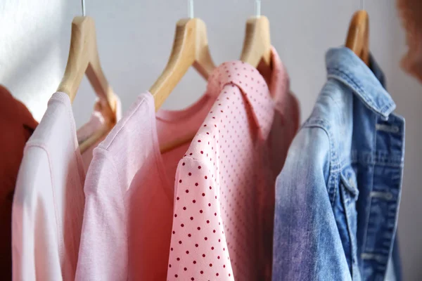Rack with hanging clothes indoors, closeup — Stock Photo, Image