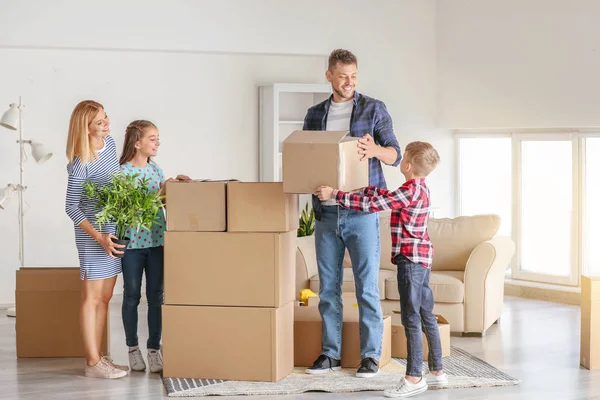 Happy family with belongings in their new house — Stock Photo, Image
