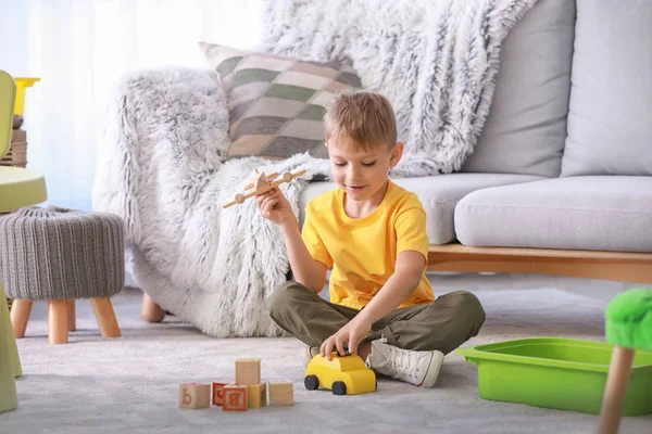 Cute little boy playing with toys at home — Stock Photo, Image