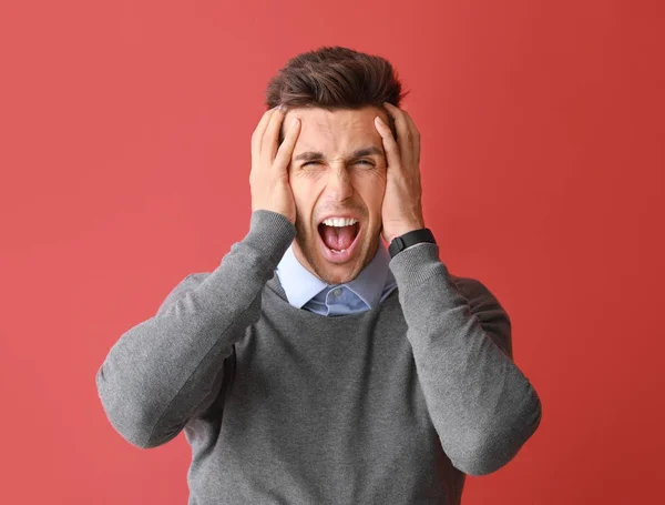 Stressed young man on color  background — Stock Photo, Image