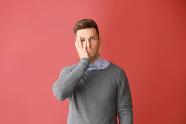 Stressed young man on color  background — Stock Photo, Image