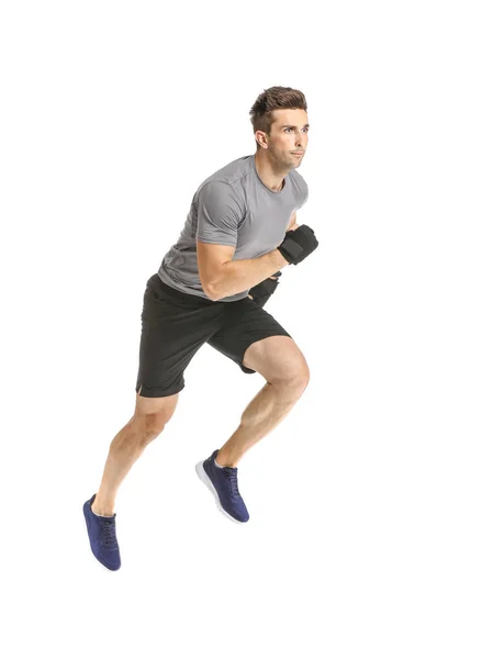 Running sporty man with wrist bands on white background — Stock Photo, Image