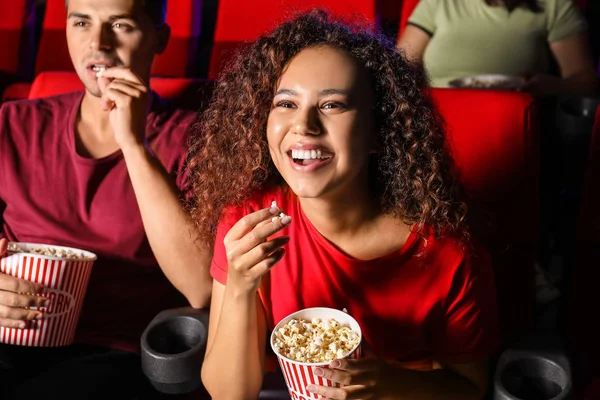 Couple with popcorn watching movie in cinema — Stock Photo, Image