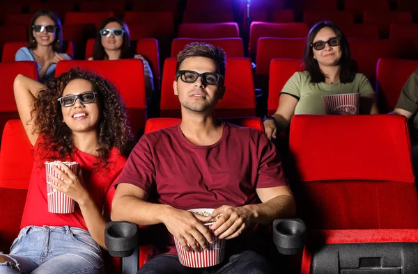 Couple with popcorn watching movie in cinema — Stock Photo, Image
