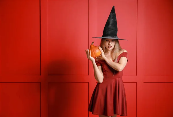 Bella donna vestita da strega per Halloween su sfondo a colori — Foto Stock
