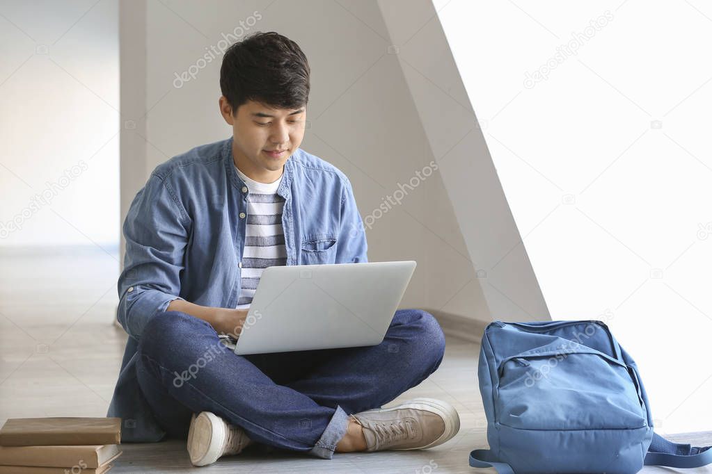 Asian student with laptop preparing for exam at the university