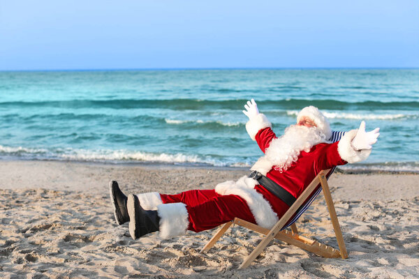 Happy Santa Claus resting at sea resort