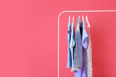 Renkli arka planda asılı giysiler ile Raf