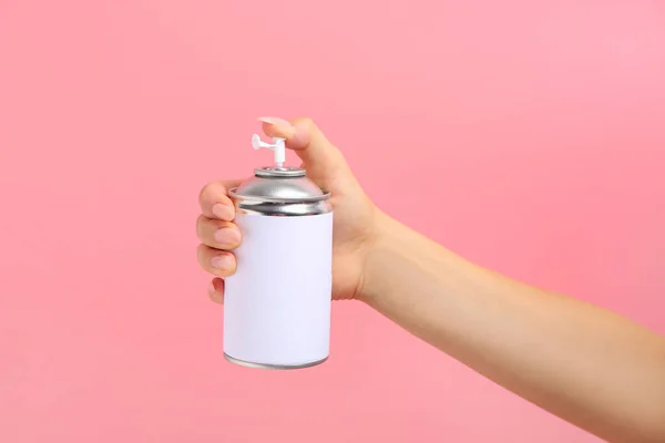 Female hand with bottle of air freshener on color background — Stock Photo, Image