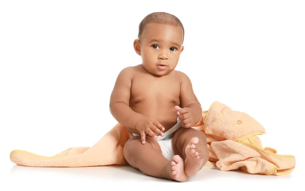 Cute African-American baby with soft towel on white background — Stock Photo, Image