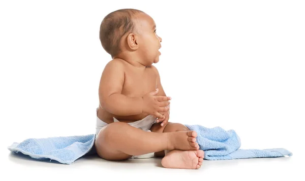Cute African-American baby with soft towel on white background — Stock Photo, Image
