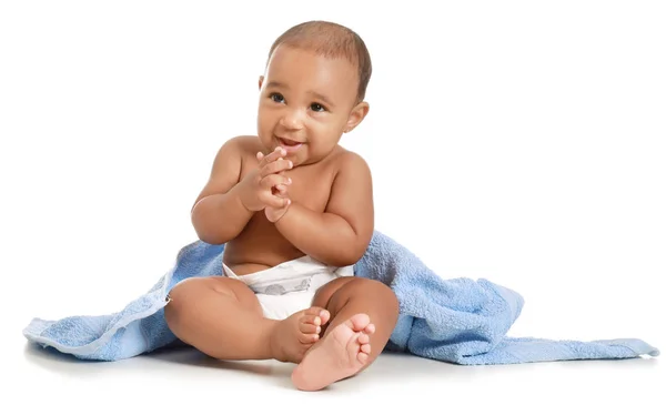 Cute African-American baby with soft towel on white background — Stock Photo, Image